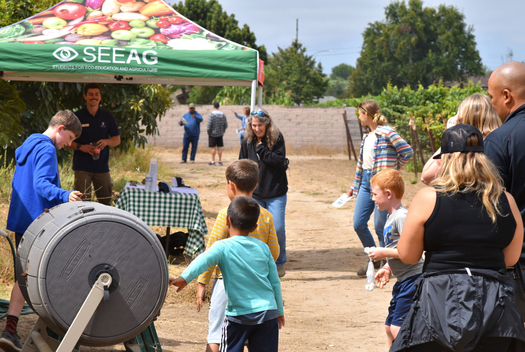 Families arrive at the Allan Hancock College Vineyard to learn about fresh fruits and vegetables.